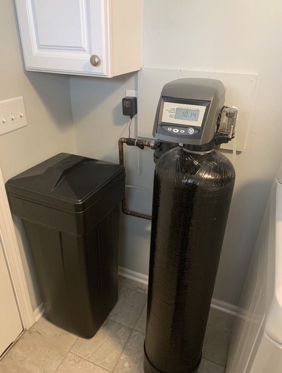 Softener and brine tank installed in a finished laundry room